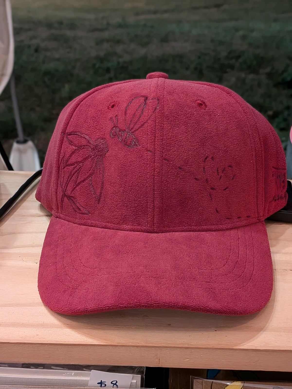 Cap with flower and bee
